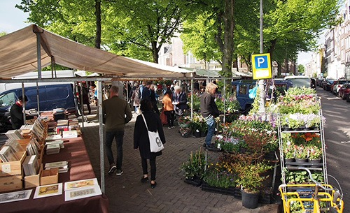 books and flowers at the saturday noorder flea market amsterdam