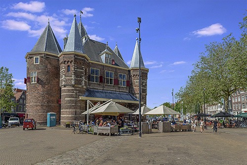one of the former city gates is the waag, meaning weigh house, and is now a restaurant with terrace in the newmarket area