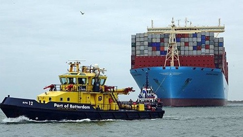 tugboat 12 port of rotterdam and huge container ship