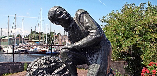 statue of Hans Brinker in spaarnedam haarlem plugging the dike with his finger. dedicated to our youth, to honor the boy who symbolizes the perpetual struggle of Holland against the water